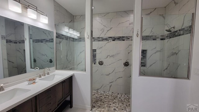 bathroom with a sink, double vanity, and a walk in shower