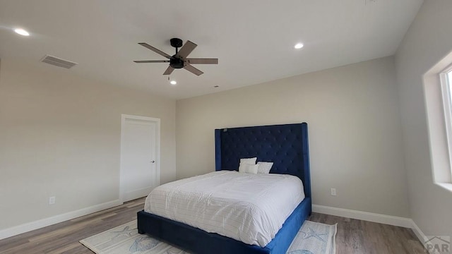 bedroom with visible vents, recessed lighting, baseboards, and wood finished floors