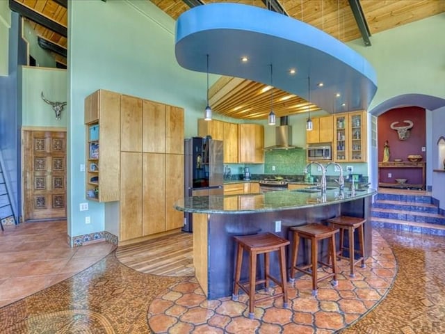 1441 Forest Rd Unit 507 1A, Creede, CO 81130 - kitchen featuring stainless steel appliances, high vaulted ceiling, wooden ceiling with exposed beams, wall chimney exhaust hood, and arched walkways