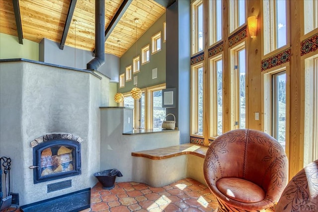 1441 Forest Rd Unit 507 1A, Creede, CO 81130 - living area with wooden ceiling with exposed beams, high vaulted ceiling, healthy amount of natural light, and a fireplace