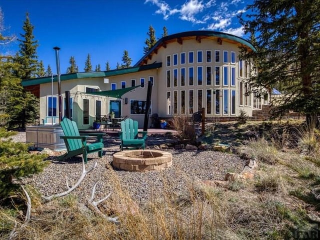 1441 Forest Rd Unit 507 1A, Creede, CO 81130 - rear view of property with an outdoor fire pit, stucco siding, and a patio