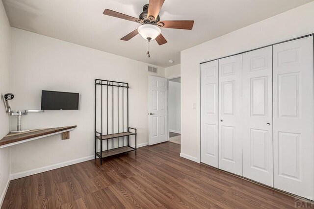 1153 E Linda Ave, Pueblo West, CO 81007 - unfurnished bedroom featuring wood finished floors, a closet, baseboards, and a ceiling fan