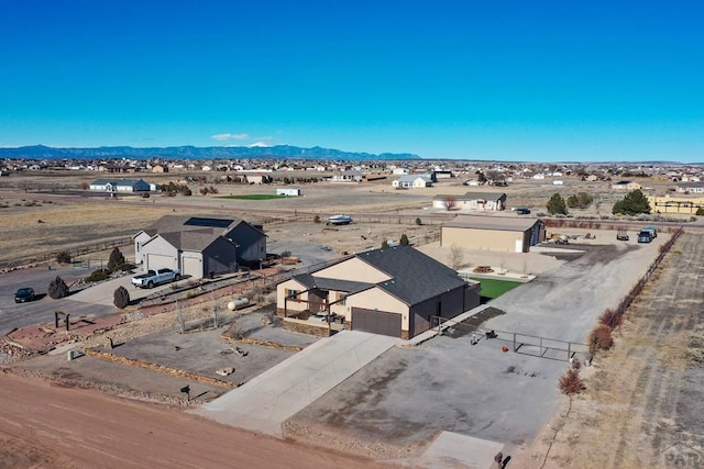 birds eye view of property with a mountain view