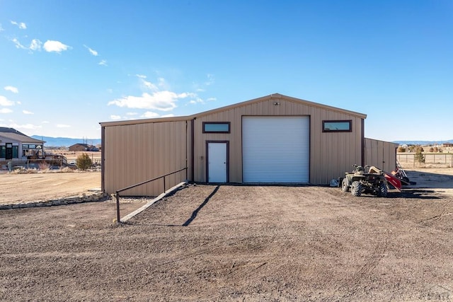 view of outdoor structure with a mountain view and dirt driveway