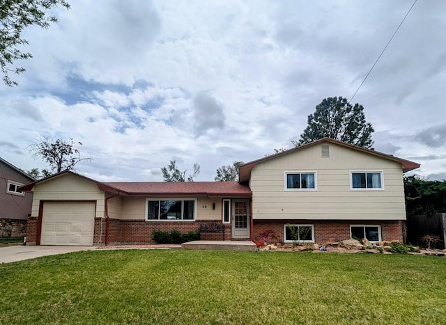 split level home featuring an attached garage, a front lawn, and brick siding