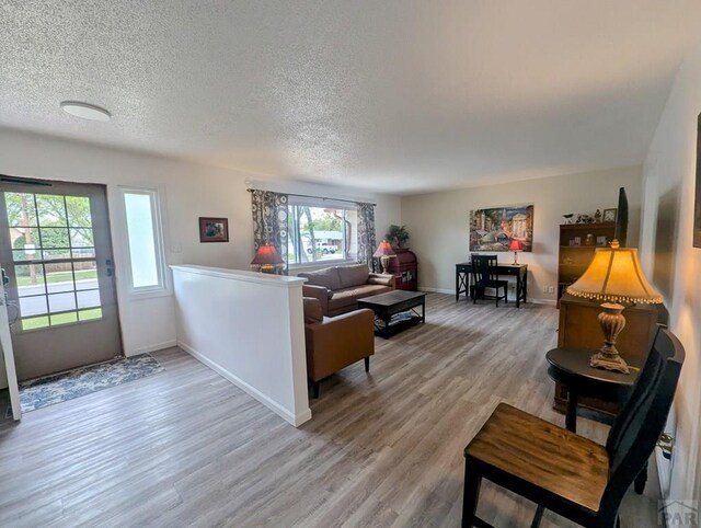 kitchen featuring open shelves, a sink, light wood finished floors, light countertops, and stainless steel dishwasher