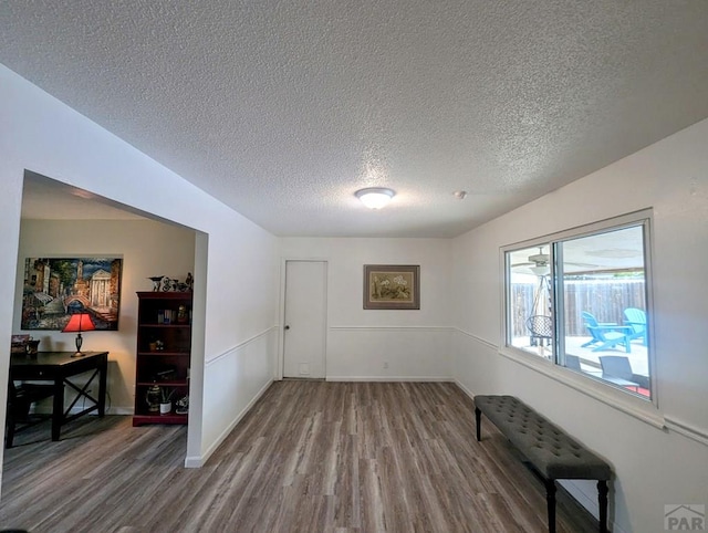 unfurnished living room featuring built in shelves, a fireplace, a textured ceiling, and visible vents