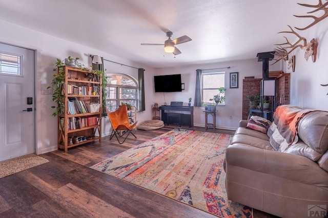 1501 Stonewall, Trinidad, CO 81082 - living room with wood finished floors, a wood stove, and a ceiling fan
