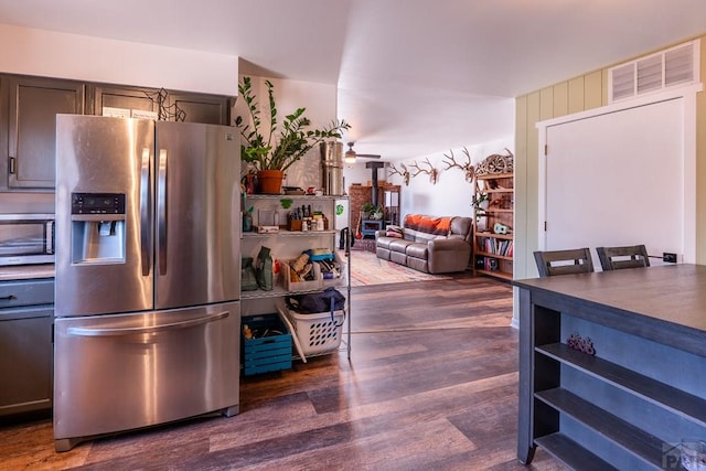 1501 Stonewall, Trinidad, CO 81082 - kitchen with stainless steel fridge, dark wood-type flooring, ceiling fan, and dark countertops