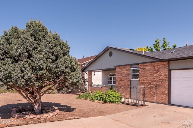 1501 Stonewall, Trinidad, CO 81082 - view of front of home with brick siding, concrete driveway, and a garage