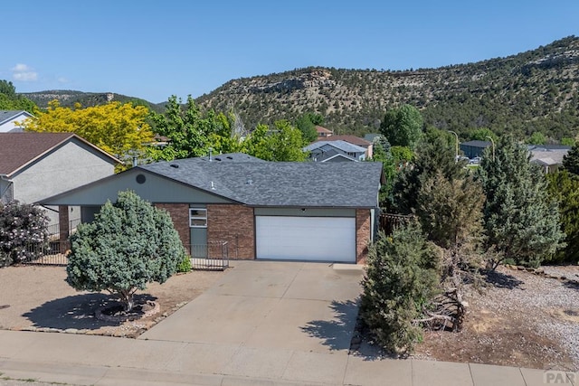 1501 Stonewall, Trinidad, CO 81082 - view of front of property with brick siding, an attached garage, concrete driveway, and a shingled roof