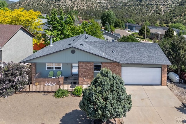 1501 Stonewall, Trinidad, CO 81082 - ranch-style home with brick siding, a garage, concrete driveway, and a shingled roof