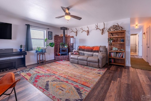 1501 Stonewall, Trinidad, CO 81082 - living area featuring a wood stove, wood finished floors, and a ceiling fan