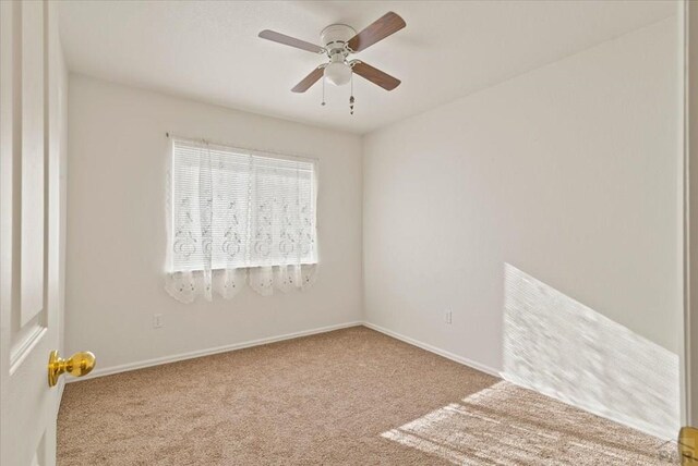 spare room featuring ceiling fan, baseboards, and carpet flooring