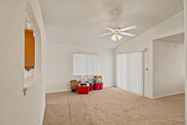 recreation room with light carpet, vaulted ceiling, and a ceiling fan