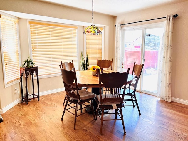dining room with baseboards and light wood-style floors