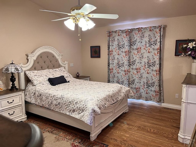 bedroom featuring baseboards, ceiling fan, wood finished floors, and visible vents