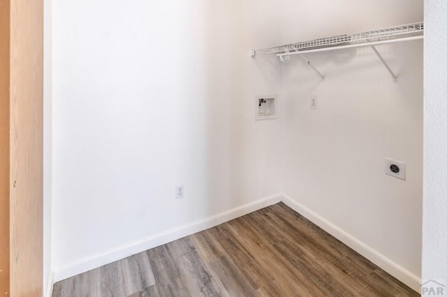 clothes washing area with washer hookup, hookup for an electric dryer, baseboards, and wood finished floors