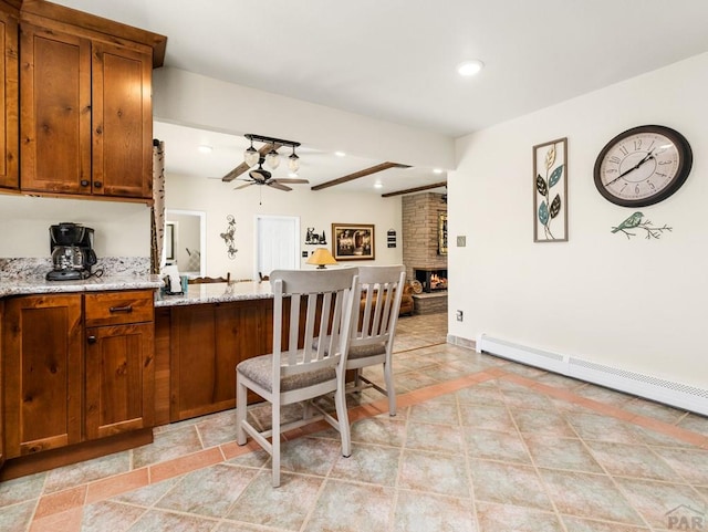kitchen featuring baseboard heating, recessed lighting, a peninsula, brown cabinets, and ceiling fan