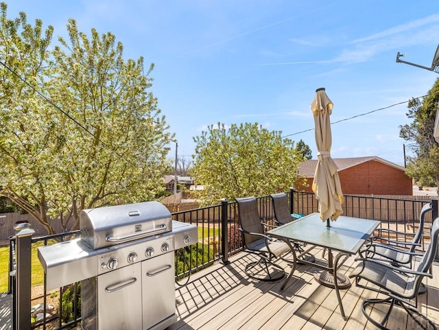 wooden terrace featuring outdoor dining area and fence private yard