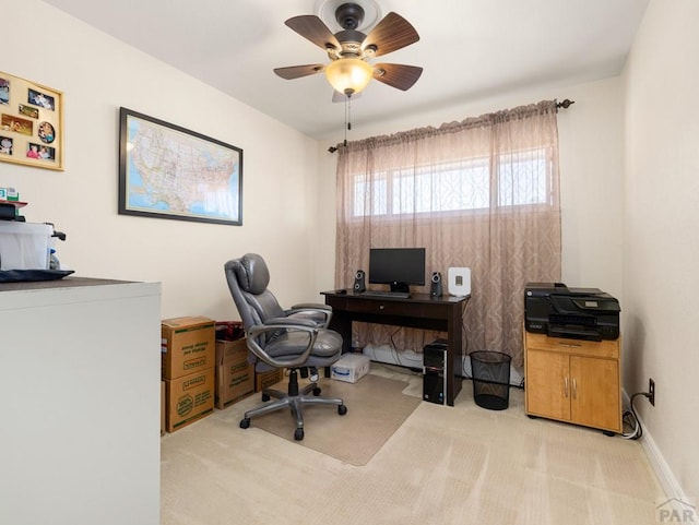 carpeted office space featuring ceiling fan