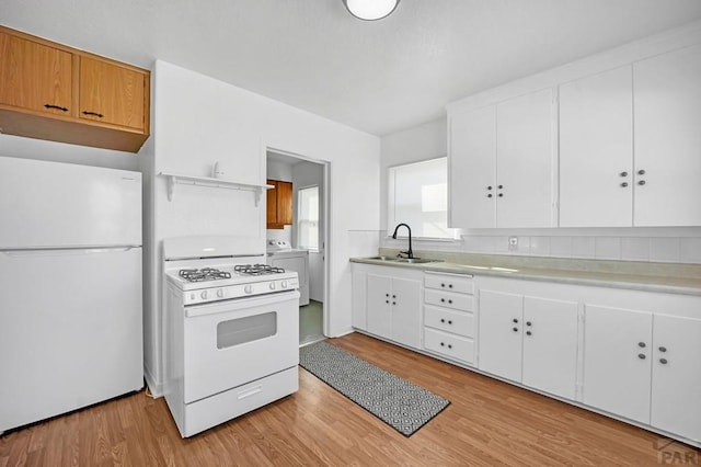 kitchen with white appliances and white cabinetry