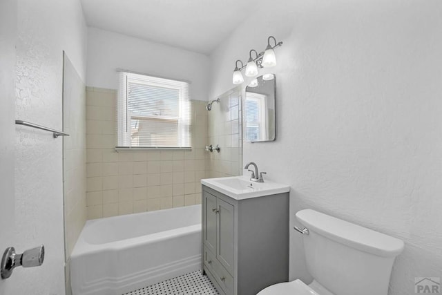 full bathroom featuring bathtub / shower combination, a textured wall, vanity, and toilet