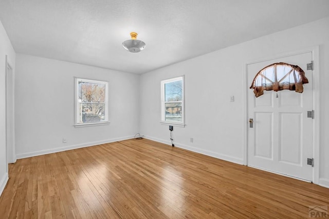 entrance foyer featuring wood finished floors and baseboards