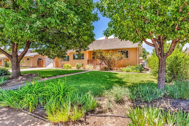 1215 Greenwood Ave, Canon City, CO 81212 - view of front of house with a front lawn, stucco siding, and a chimney