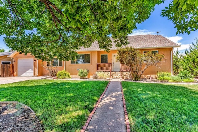 1215 Greenwood Ave, Canon City, CO 81212 - view of front of house featuring stucco siding, a garage, a front yard, and driveway