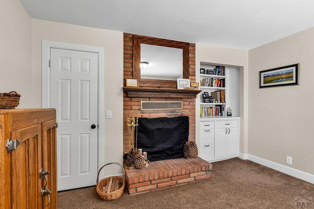 1215 Greenwood Ave, Canon City, CO 81212 - carpeted living area featuring a brick fireplace, built in features, and a textured ceiling