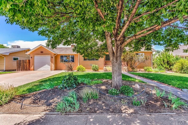 1215 Greenwood Ave, Canon City, CO 81212 - view of front of home featuring a garage, driveway, and stucco siding