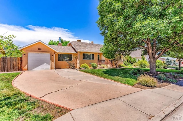 1215 Greenwood Ave, Canon City, CO 81212 - ranch-style home featuring a chimney, an attached garage, and concrete driveway