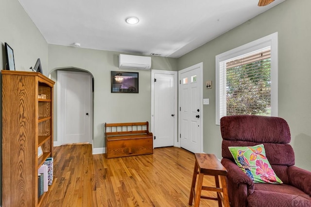 1215 Greenwood Ave, Canon City, CO 81212 - foyer with an AC wall unit, wood finished floors, and arched walkways