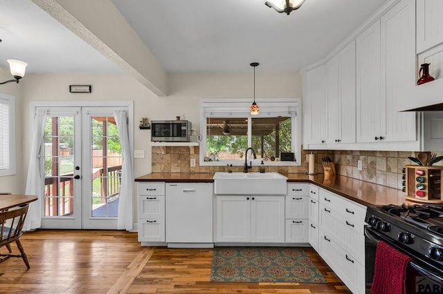 1215 Greenwood Ave, Canon City, CO 81212 - kitchen with dishwasher, stainless steel microwave, french doors, and dark countertops