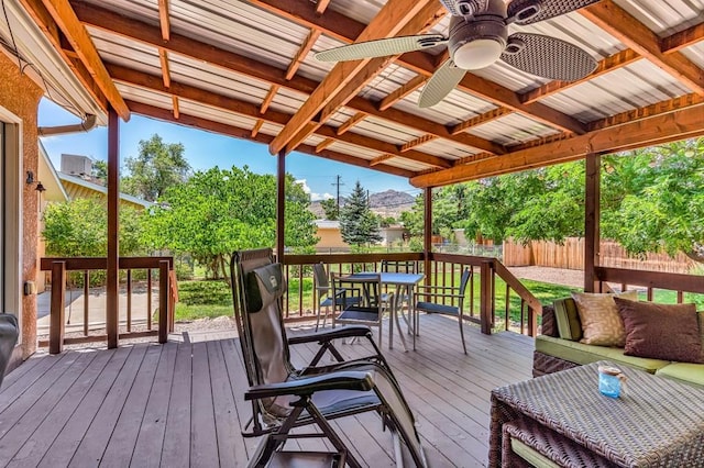 1215 Greenwood Ave, Canon City, CO 81212 - wooden deck featuring a ceiling fan, a fenced backyard, outdoor dining area, and an outdoor hangout area