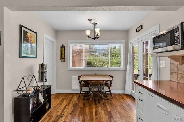 1215 Greenwood Ave, Canon City, CO 81212 - dining space with wood finished floors and a chandelier