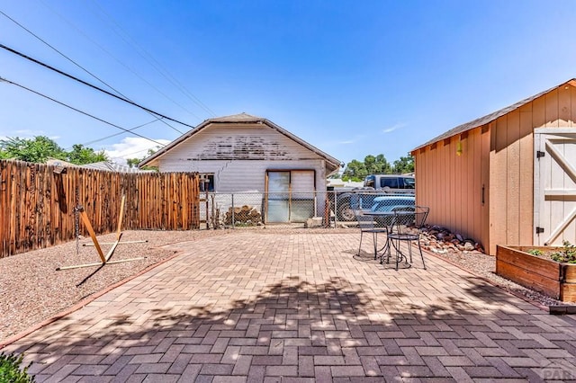 1215 Greenwood Ave, Canon City, CO 81212 - fenced backyard with a patio area and an outbuilding