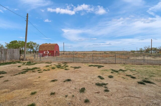2615 Lambert Ave, Pueblo, CO 81003 - view of yard with fence, a barn, an outdoor structure, and a rural view