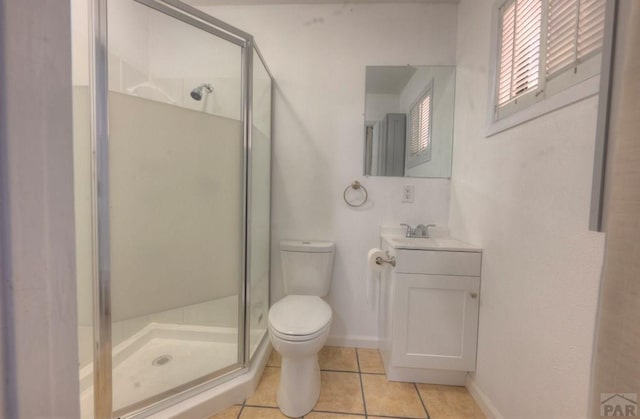 2000 Comanche Dr, Walsenburg, CO 81089 - bathroom with toilet, tile patterned flooring, a stall shower, vanity, and baseboards