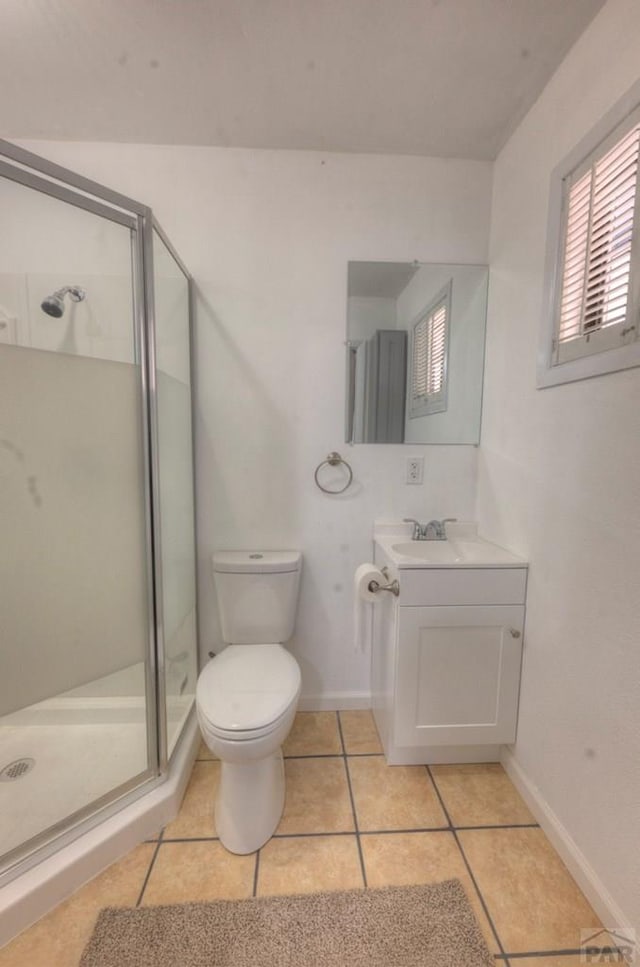 2000 Comanche Dr, Walsenburg, CO 81089 - bathroom featuring a stall shower, tile patterned flooring, vanity, toilet, and baseboards