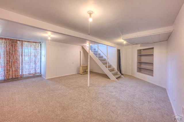 2000 Comanche Dr, Walsenburg, CO 81089 - below grade area with stairs, carpet floors, baseboards, and built in shelves