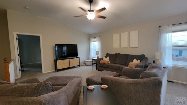 living area with light carpet, plenty of natural light, a ceiling fan, and vaulted ceiling