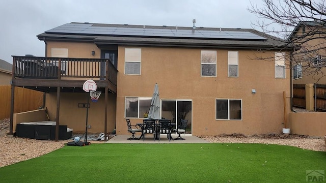 back of property with a yard, a patio area, fence, and stucco siding