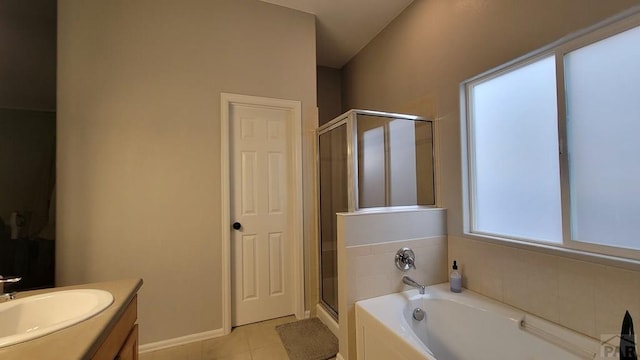 bathroom featuring vanity, baseboards, a stall shower, a garden tub, and tile patterned floors