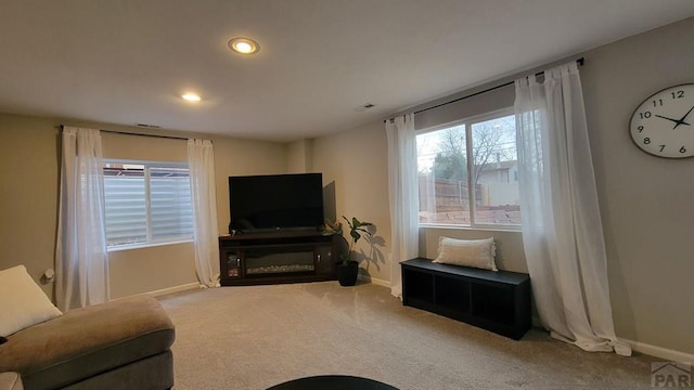 living room featuring recessed lighting, baseboards, and carpet floors