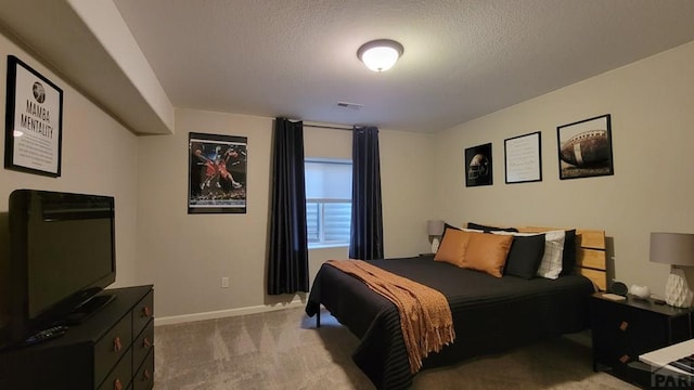 carpeted bedroom with visible vents, baseboards, and a textured ceiling