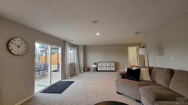 living room with light carpet, visible vents, recessed lighting, and baseboards