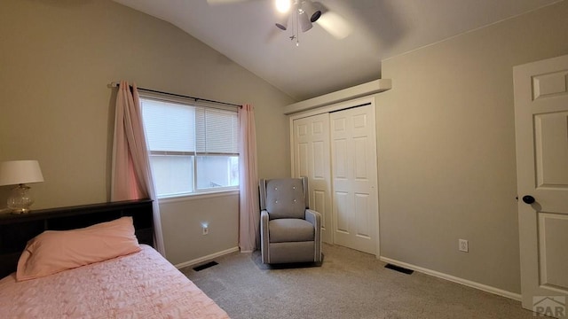 bedroom with visible vents, baseboards, lofted ceiling, carpet flooring, and a closet