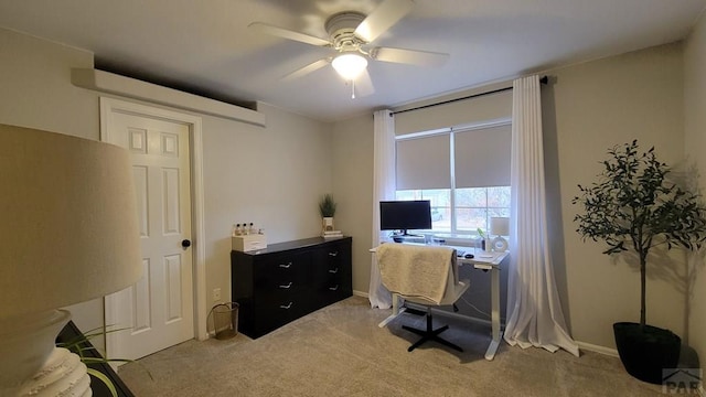 office space featuring light carpet and ceiling fan